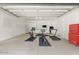 Finished garage space used as home gym with work out equipment and tool storage at 35556 N 87Th Pl, Scottsdale, AZ 85266