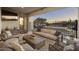 Covered patio with comfortable seating overlooking the pool and desert landscape, ideal for relaxing or entertaining guests at 35556 N 87Th Pl, Scottsdale, AZ 85266