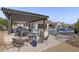 Resort-style backyard with a pool, spa, outdoor kitchen, and multiple seating areas, ideal for entertaining or relaxing at 35556 N 87Th Pl, Scottsdale, AZ 85266