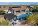 Expansive backyard features a pristine pool, outdoor kitchen, and desert landscape at 35556 N 87Th Pl, Scottsdale, AZ 85266