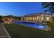 Stunning backyard with a pool, spa, fire pit, and well-manicured lawn at 35556 N 87Th Pl, Scottsdale, AZ 85266