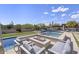 Inviting poolside seating area with a fire feature, perfect for enjoying warm evenings and creating lasting memories at 35556 N 87Th Pl, Scottsdale, AZ 85266