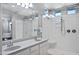 Bright bathroom featuring double sinks, granite countertops, large mirror, and stand-up shower with bench at 3890 E Perkinsville St, Gilbert, AZ 85295