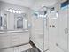 Bright bathroom featuring double sinks, granite countertops, large mirror, and stand-up shower at 3890 E Perkinsville St, Gilbert, AZ 85295