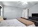 Comfortable bedroom with ceiling fan, decorative lighting, wood-look tile floors, and closet access at 3890 E Perkinsville St, Gilbert, AZ 85295