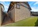 Exterior shot of home with stucco wall, small windows and manicured lawn at 3890 E Perkinsville St, Gilbert, AZ 85295