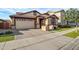 Lovely home exterior featuring a two-car garage, brick accents, and tidy landscaping at 3890 E Perkinsville St, Gilbert, AZ 85295