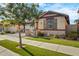 Beautiful home exterior featuring a well-maintained lawn, garden beds, and a tree that provides ample shade at 3890 E Perkinsville St, Gilbert, AZ 85295