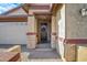 Charming front entrance with brick accents, covered porch, and wooden front door with wreath at 3890 E Perkinsville St, Gilbert, AZ 85295
