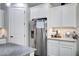 Kitchen featuring a stainless steel refrigerator and white cabinetry at 3890 E Perkinsville St, Gilbert, AZ 85295