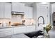 Kitchen area with sleek granite counters, modern appliances, and white cabinetry at 3890 E Perkinsville St, Gilbert, AZ 85295