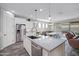 Bright kitchen with stainless appliances, granite countertops, and an island with sink and dishwasher at 3890 E Perkinsville St, Gilbert, AZ 85295