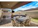 Covered patio with string lights, a dining table, outdoor seating, and a mounted television at 3890 E Perkinsville St, Gilbert, AZ 85295