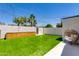 Beautiful backyard area with artificial grass, privacy wall, and a cozy egg chair on tile at 4246 E Mulberry Dr, Phoenix, AZ 85018