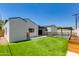 Landscaped backyard features artificial grass, in-ground pool with safety fence, and modern architectural home at 4246 E Mulberry Dr, Phoenix, AZ 85018