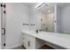Modern bathroom boasts a sleek vanity with white countertop, dark hardware, and a glass enclosed shower at 4246 E Mulberry Dr, Phoenix, AZ 85018