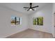 An empty bedroom with light wood floors, white walls, black trim windows, and a ceiling fan at 4246 E Mulberry Dr, Phoenix, AZ 85018