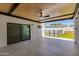 Covered patio area with tiled flooring, a ceiling fan, and open view to the fenced in backyard at 4246 E Mulberry Dr, Phoenix, AZ 85018
