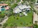 Expansive modern home with lush landscaping, a pristine pool, and a multi-car driveway, set in a desert landscape at 4451 E Joshua Tree Ln, Paradise Valley, AZ 85253