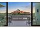 Enjoy sunset views on the balcony overlooking mountain, desert, and city landscape at 4451 E Joshua Tree Ln, Paradise Valley, AZ 85253