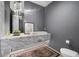 Chic bathroom with marble countertop, modern lighting, a decorative mirror, and a luxurious area rug at 4451 E Joshua Tree Ln, Paradise Valley, AZ 85253