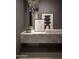 Stylish bathroom featuring a marble countertop, unique artwork, and modern lighting at 4451 E Joshua Tree Ln, Paradise Valley, AZ 85253