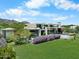 Contemporary home features a large yard, a swimming pool, desert landscaping, and mountain views at 4451 E Joshua Tree Ln, Paradise Valley, AZ 85253