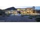 Elegant modern home at twilight featuring a fire pit, and seamless indoor-outdoor living at 4451 E Joshua Tree Ln, Paradise Valley, AZ 85253