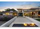 Stunning modern home with fire feature, pool, and desert landscaping at 4451 E Joshua Tree Ln, Paradise Valley, AZ 85253