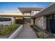 Modern home features unique desert landscaping, stone accents, and an inviting entrance at 4451 E Joshua Tree Ln, Paradise Valley, AZ 85253
