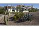 Contemporary home with desert landscaping including various cacti and desert scrub at 4451 E Joshua Tree Ln, Paradise Valley, AZ 85253