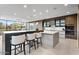 Modern kitchen with sleek countertops, stainless steel appliances, and a breakfast bar with seating at 4451 E Joshua Tree Ln, Paradise Valley, AZ 85253