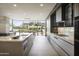 Sleek, modern kitchen with stainless steel appliances, a center island, and large windows with a beautiful mountain view at 4451 E Joshua Tree Ln, Paradise Valley, AZ 85253