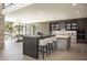 Open-concept kitchen with a breakfast bar, modern appliances, and views of the dining area at 4451 E Joshua Tree Ln, Paradise Valley, AZ 85253