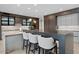 Modern kitchen features a large center island, bar stool seating, and custom cabinets at 4451 E Joshua Tree Ln, Paradise Valley, AZ 85253