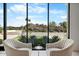 Living room seating area boasts large windows with views of landscaped backyard at 4451 E Joshua Tree Ln, Paradise Valley, AZ 85253