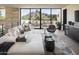 Bright living room with mountain views and modern furnishings, including a large sectional and sleek gray arm chair at 4451 E Joshua Tree Ln, Paradise Valley, AZ 85253