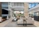 Elegant living room with a fireplace, soaring ceilings, floor-to-ceiling windows, and mountain views at 4451 E Joshua Tree Ln, Paradise Valley, AZ 85253