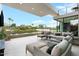 Inviting outdoor patio with comfortable seating, lush landscaping, and a tranquil water feature at 4451 E Joshua Tree Ln, Paradise Valley, AZ 85253