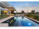 Backyard pool features modern design and a built in jacuzzi; great for entertaining at 4451 E Joshua Tree Ln, Paradise Valley, AZ 85253
