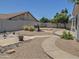 Backyard with walkway, desert landscaping, privacy fence, and seating area at 4517 E Ute St, Phoenix, AZ 85044