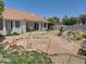 Beautiful backyard with covered patio, lush landscaping, and privacy wall at 4517 E Ute St, Phoenix, AZ 85044
