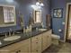 Stylish bathroom with a double vanity, modern fixtures, and elegant blue walls at 4517 E Ute St, Phoenix, AZ 85044