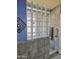 Bright bathroom featuring glass block window, tile shower, and a modern towel bar at 4517 E Ute St, Phoenix, AZ 85044