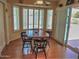 Cozy dining area with wood floors, a bay window, and a sliding glass door to the patio at 4517 E Ute St, Phoenix, AZ 85044