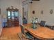 A spacious dining room featuring hardwood floors and a wooden table, adjacent to a beautiful china cabinet at 4517 E Ute St, Phoenix, AZ 85044
