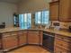 Bright kitchen with wood cabinets, granite countertops, and stainless steel dishwasher at 4517 E Ute St, Phoenix, AZ 85044