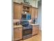 Kitchen with a black oven, matching microwave, and wood cabinets with stainless steel hardware at 4517 E Ute St, Phoenix, AZ 85044