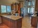 Open concept kitchen with granite countertops, wood cabinets, and stainless steel appliances at 4517 E Ute St, Phoenix, AZ 85044
