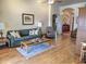 Cozy living room featuring hardwood floors, a comfortable sofa, and a ceiling fan at 4517 E Ute St, Phoenix, AZ 85044